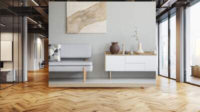 Grey couch with patterned cushion standing in real photo of bright sitting room interior with white cupboard with decor and poster with fabric hanging on the wall Wall mural