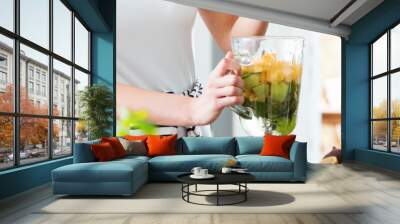 Healthy person preparing fruit cocktail Wall mural