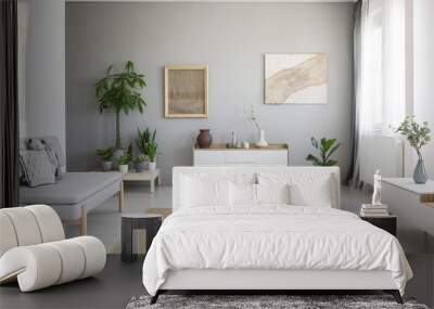 Real photo of bright Nordic style living room interior with fresh plants, white cupboard, window with drapes, grey sofa and big carpet on the floor Wall mural