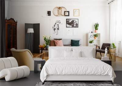 Retro beige armchair and pouf on the cozy carpet in contemporary living room interior with grey sofa and vintage furniture Wall mural