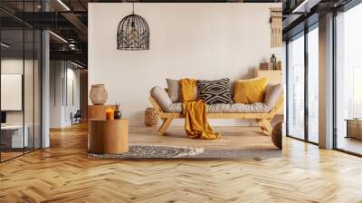 scandinavian sofa with pillows and dark yellow blanket in bright living room interior with black cha Wall mural