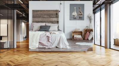 Spacious, feminine bedroom interior with rustic furniture, white walls, wooden crates and oil painting of animals. Real photo Wall mural