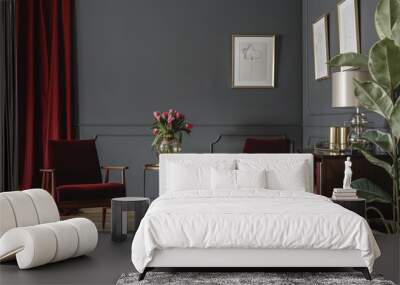 Two burgundy armchairs placed in grey living room interior with red drape. molding on the wall with posters, fresh flowers in glass vase and wooden cupboard Wall mural