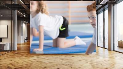 Young boy during corrective gymnastics Wall mural