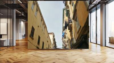 NAPLES, ITALY - JANUARY 28, 2017 : street view of old city center of Naples with clothes hanged in the street. Wall mural