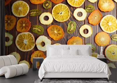 Colorful fruit chips on dark wood table Wall mural