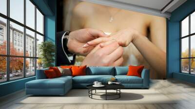 golden ring putted on a finger Wall mural