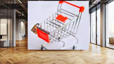 Miniature shopping cart with lock on it against white background as online and retail shopping is closed due to Corona Virus (Covid-19) disease pandemic. Only essential services open. Concept Lockdown Wall mural