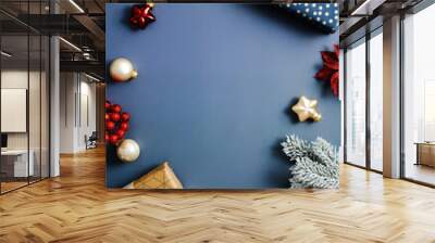 Christmas composition. Frame made of Christmas gift boxes, baubles and fir branches on blue table. Top view with copy space. Flat lay. Wall mural