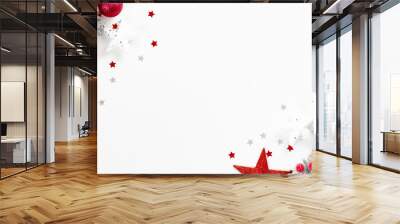 Christmas tree branches with red balls and stars over white background with confetti. Christmas greeting card mockup, winter holiday postcard template Wall mural