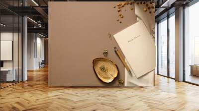 Feminine workspace, home office desk table top view. Weekly planner, office stationery, dried flowers on brown table. Elegant, modern style. Wall mural