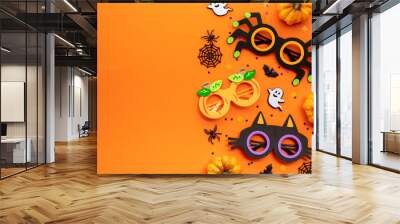 Happy Halloween concept. Modern Halloween holiday decorations with party sunglasses on orange background. Flat lay, top view, copy space. Wall mural