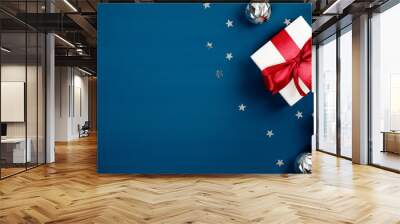 Merry Christmas and Happy Holidays greeting card, poster, Xmas banner mockup. Christmas gift boxes with red bows and silver balls on dark blue background. Flat lay, top view. Wall mural