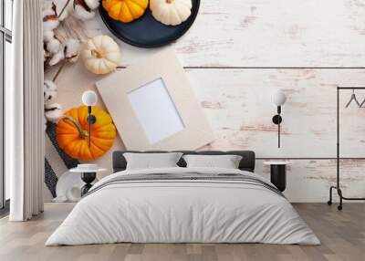 Picture frame mockup, pumpkins, candles, cotton branch on rustic wooden desk table. Autumn, fall concept. Flat lay, top view, copy space. Wall mural