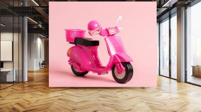 Pink vintage toy doll scooter or motorbike with helmet on pastel pink background. 80s, classic, retro style Wall mural