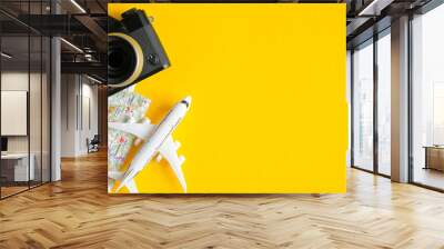 Travel planning concept. Flat lay traveler accessories on yellow background with copy space. Top view plane, map, vintage camera. Travel agency banner design template Wall mural