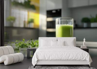 A glass of green smoothie stands on a kitchen counter next to fresh microgreens. The bright kitchen background conveys a healthy lifestyle concept Wall mural