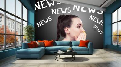 Young black haired business woman holding her hand next to her mouth in way of whispering something and multiple word News above her head, concept for news, side view shot against black background Wall mural