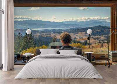 A man works from home with a view of nature outside an open window. The concept of remote work, freelancing Wall mural