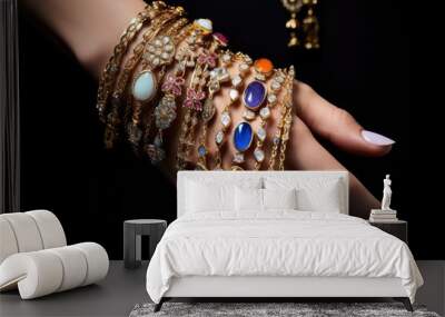 A woman's hand is adorned with a beautiful collection of many exquisite rings and bracelets in precious metals and colorful stones. Ethnic jewelry. Wall mural