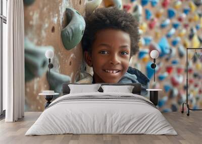 portrait of a confident African American boy, 8-10 years old, at altitude, engaged in steeplechase in an equipped climbing center on a simulator Wall mural