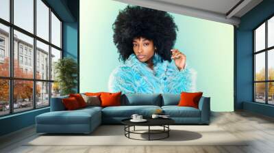 Cute young Black woman wearing a cool blue winter top Wall mural