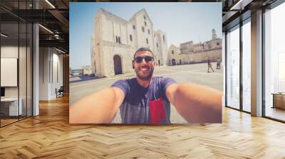 Happy tourist man take selfie in the old city of Bari, Puglia region. Italy Wall mural