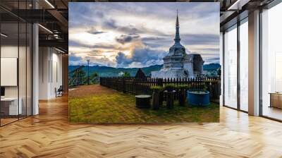 The old white pagoda on the hill on a cloudy day. You can see the village below in Chiang Mai, Thailand. Wall mural