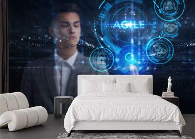 Business, Technology, Internet and network concept. Young businessman working on a virtual screen of the future and sees the inscription: Agile Wall mural