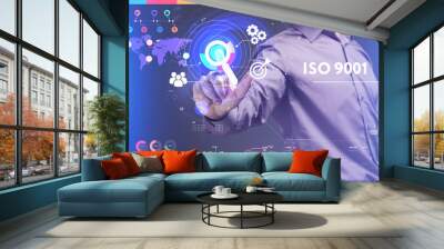 Business, Technology, Internet and network concept. Young businessman working on a virtual screen of the future and sees the inscription: ISO 9001 Wall mural