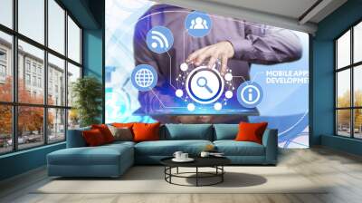 Business, Technology, Internet and network concept. Young businessman working on a virtual screen of the future and sees the inscription: Mobile apps development Wall mural