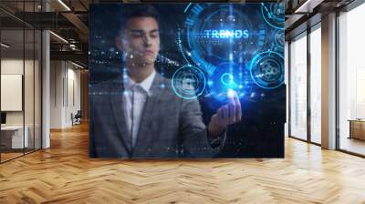 Business, Technology, Internet and network concept. Young businessman working on a virtual screen of the future and sees the inscription: Trends Wall mural