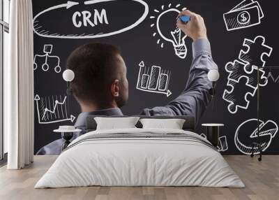 Technology, internet, business and marketing. Young business man writing word: CRM Wall mural