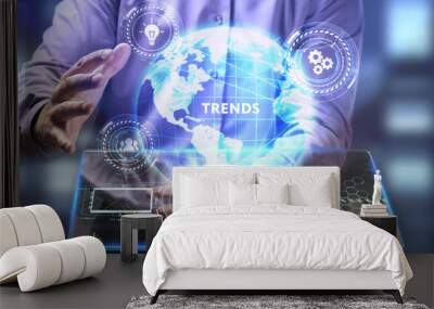 The concept of business, technology, the Internet and the network. A young entrepreneur working on a virtual screen of the future and sees the inscription: Trends Wall mural