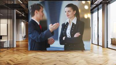 young business woman and businessman talking in the hallway Wall mural