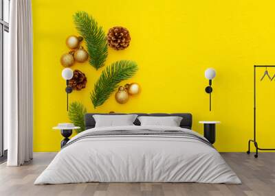 Spruce branch, cones and vintage toys decoration on christmas or new year on yellow background Wall mural