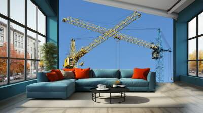 two building crane yellow and blue visually intersect Wall mural