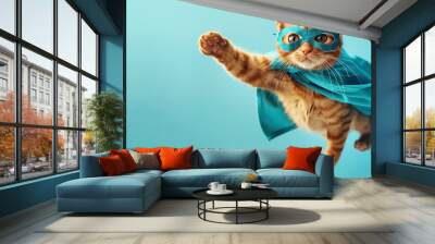 A playful ginger cat dressed as a superhero soars in a sky-blue backdrop Wall mural