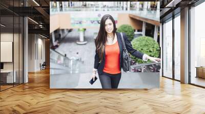 Portrait of a beautiful young businesswoman standing outside usi Wall mural