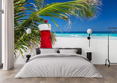 Christmas stocking on palm tree at tropical beach Wall mural