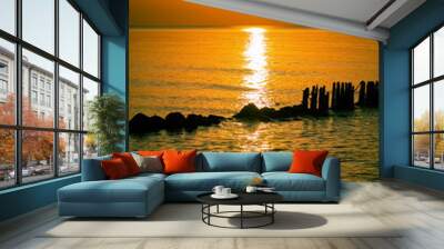 Sunset at Baltic sea, seascape with breakwaters Wall mural