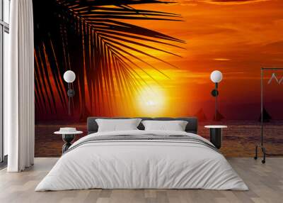 Sunset on beach with sailing boats Wall mural