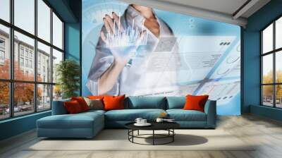 Medical concept of futuristic health care technology and augmented reality. A female doctor hand is touching a virtual innovative control panel to monitor a patient's electronic health records Wall mural