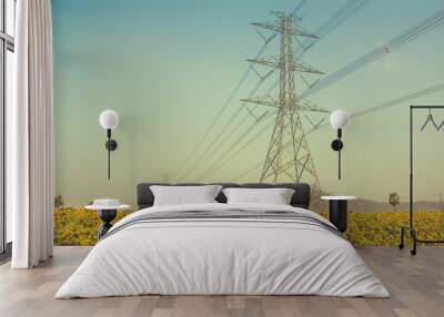 High-voltage support of a power line in the field of sunflowers. Wall mural