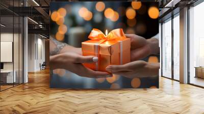 delivery of a gift colored box tied with a satin ribbon. gift in hands. holiday gift packaging Wall mural