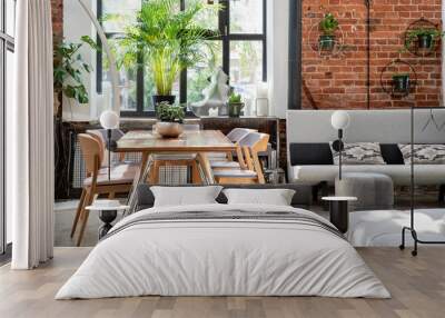 Industrial bright interior of living room in loft apartment in modern style. Bricky wall, big window and wooden table in scandinavian style. Wall mural