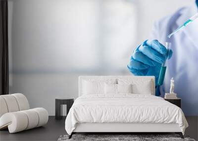 Lab practitioner working on chemical research for chemical reactions, does a chemical experiment and examines a patient's blood sample. Medicine and research concept. Wall mural