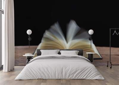 open bible on the antique wooden table in a dark room with light abstract style Wall mural