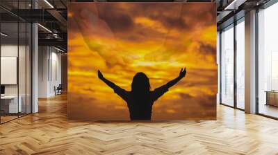 The shadow of a woman raised her hand to pray to God in heaven Style Silhouette Wall mural