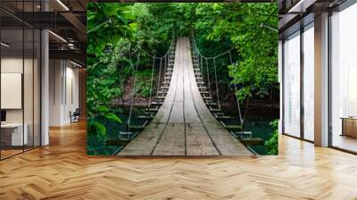 Scenic empty hanging bridge in the middle of the forest nobody around Wall mural